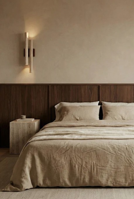 Hotel room — bed in foreground, windows looking out onto city