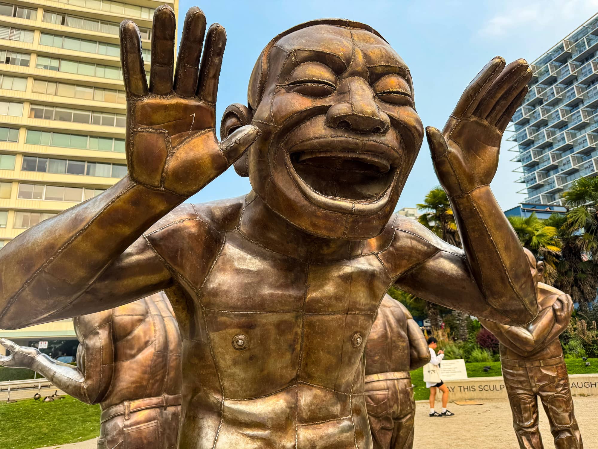 A-maze-ing Laughter — larger-than-life bronze figures by the beach