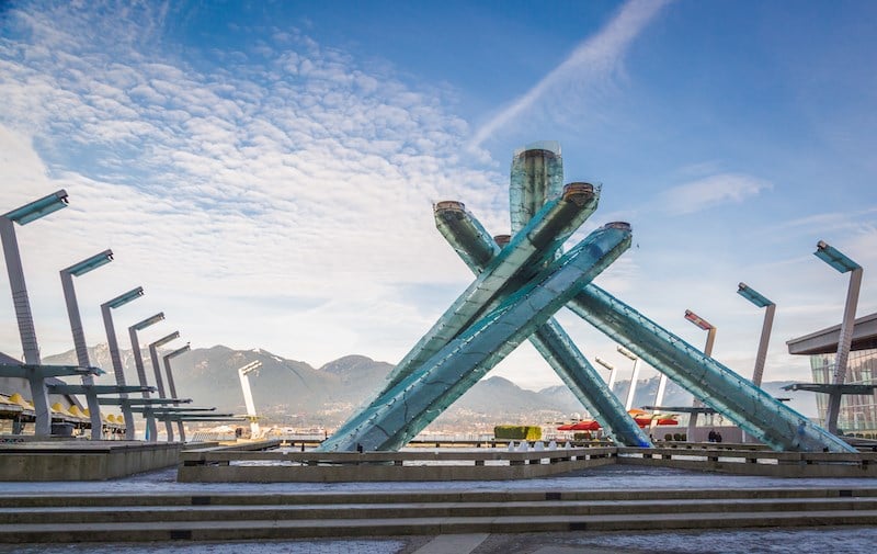 Olympic Cauldron — waterfront torch, mountains and harbour behind