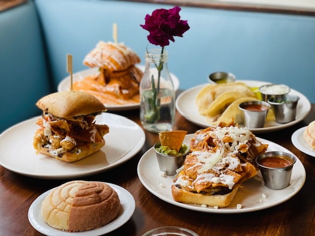 Brunch counter — stacked plates, morning light, full tables