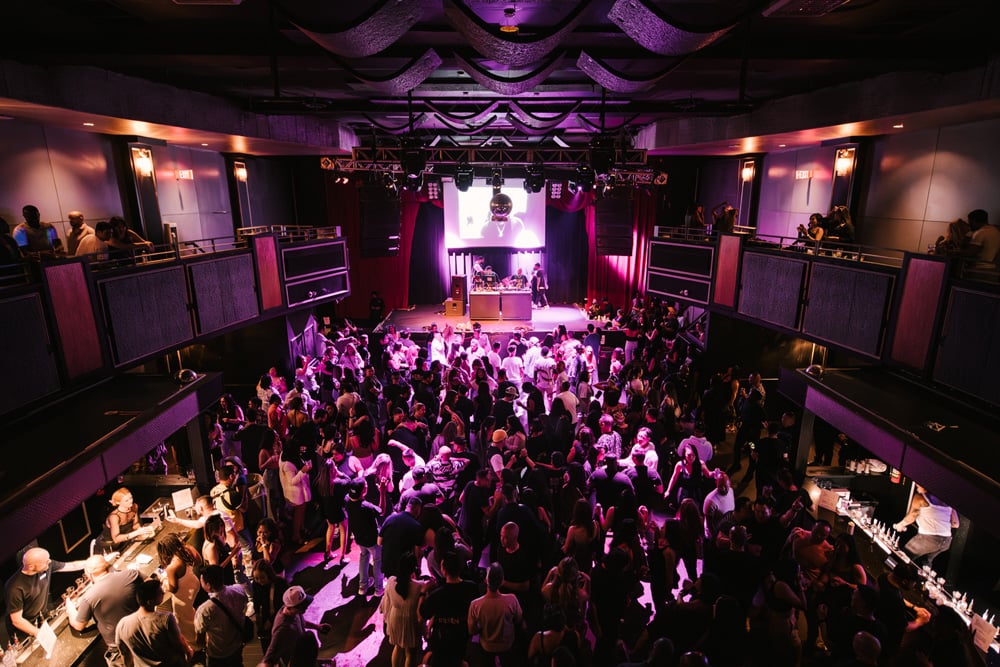 The Pearl — intimate live room, stage lights, close crowd
