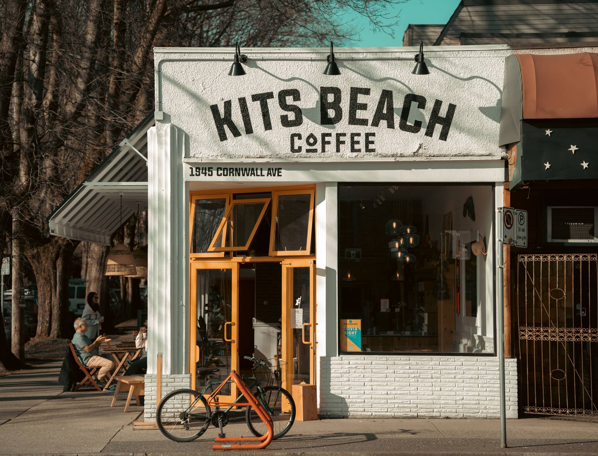 Kitsilano Beach — sand, driftwood, sunset over English Bay