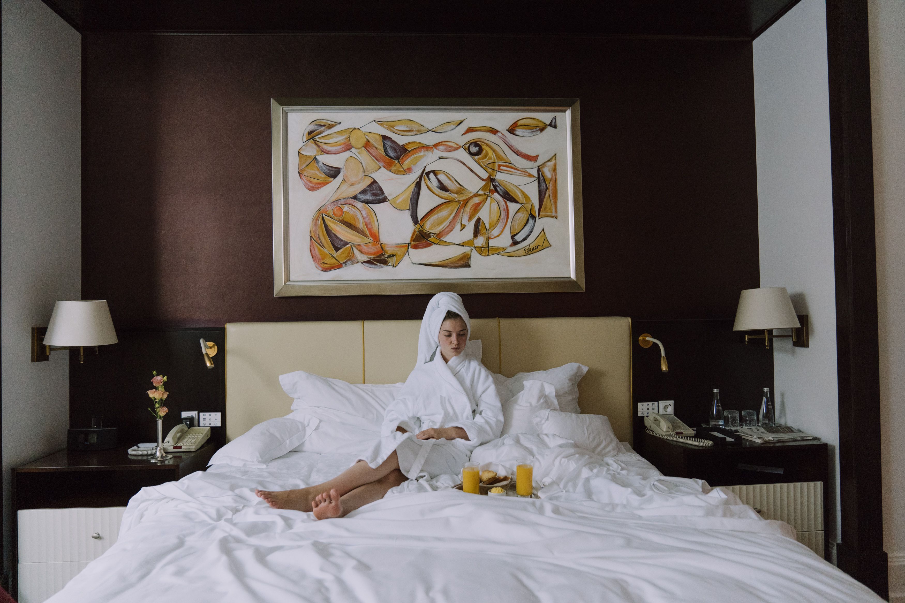 Suite morning — breakfast in bed, artwork above
