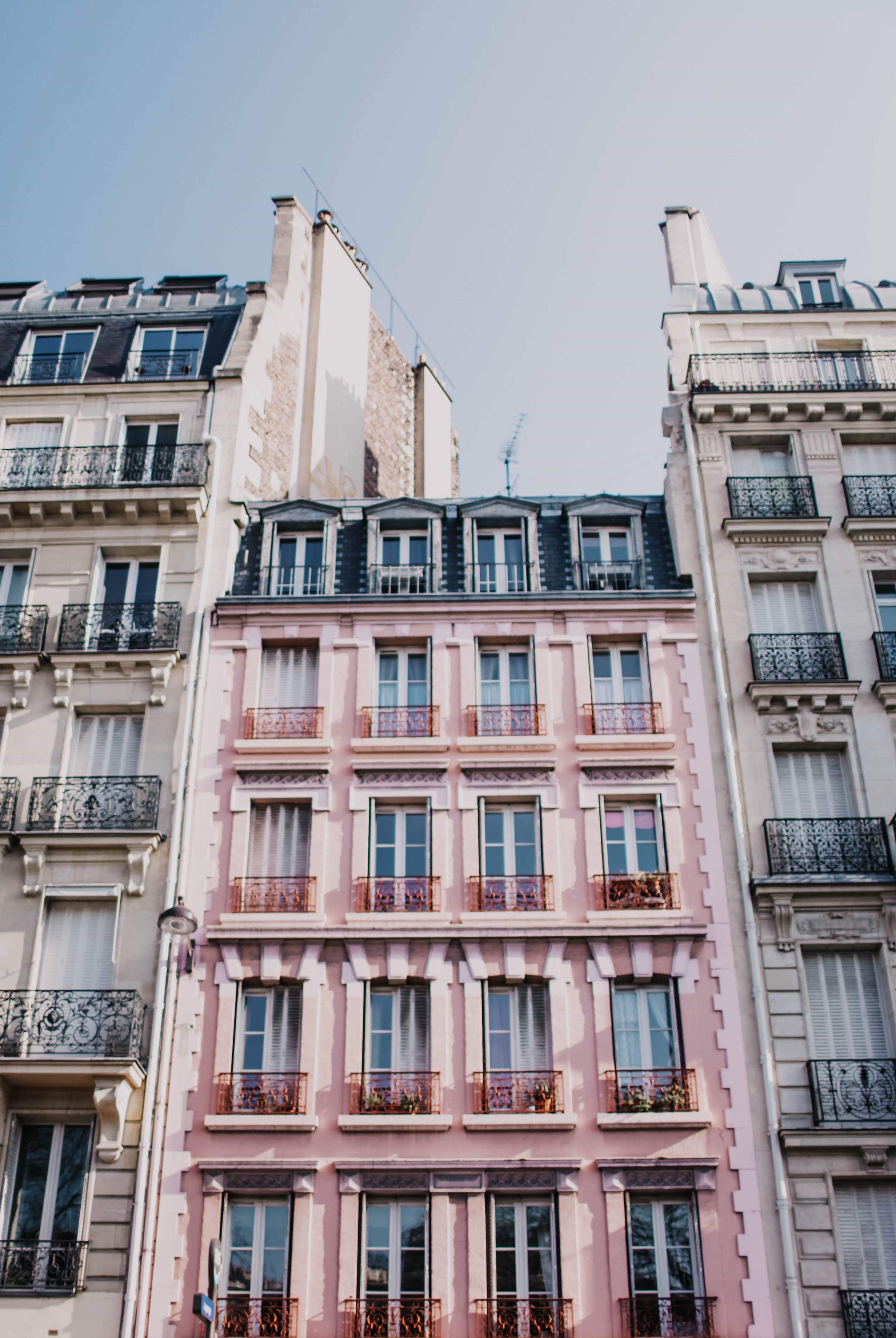 The building — Haussmann façade, rows of iron balconies