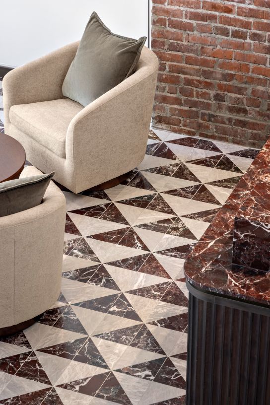 Hotel Modo lobby featuring rich wood details, marble flooring and preserved heritage character